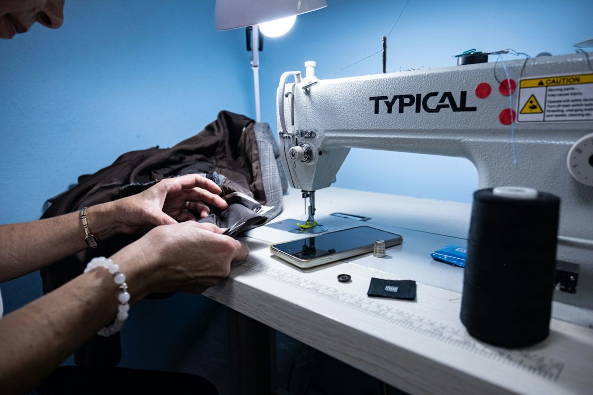 a woman is working on a sewing machine