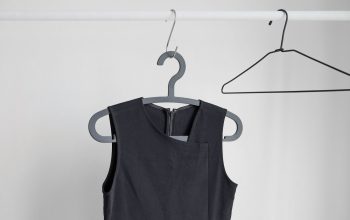 black sleeveless top hanging on wardrobe